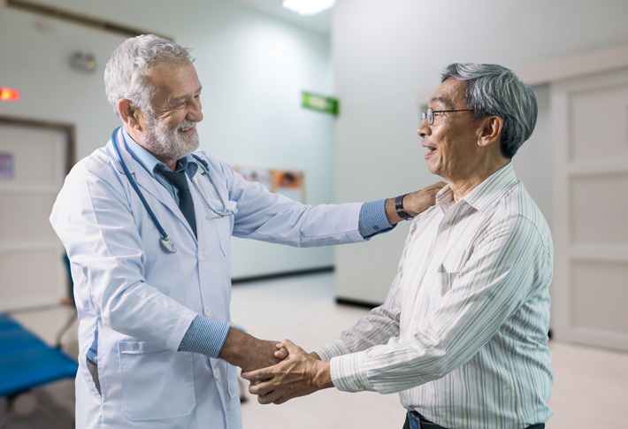 Doctor shaking hands with a patient during a clinic visit