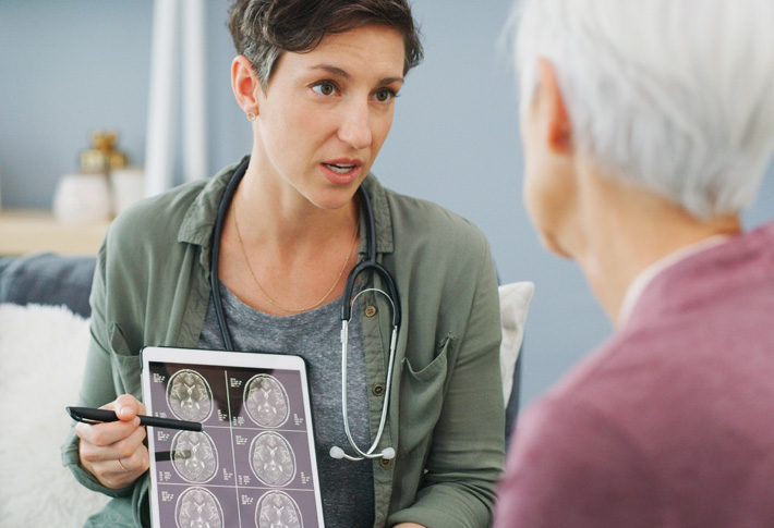 Doctor explaining brain scan results to patient during medical consultation